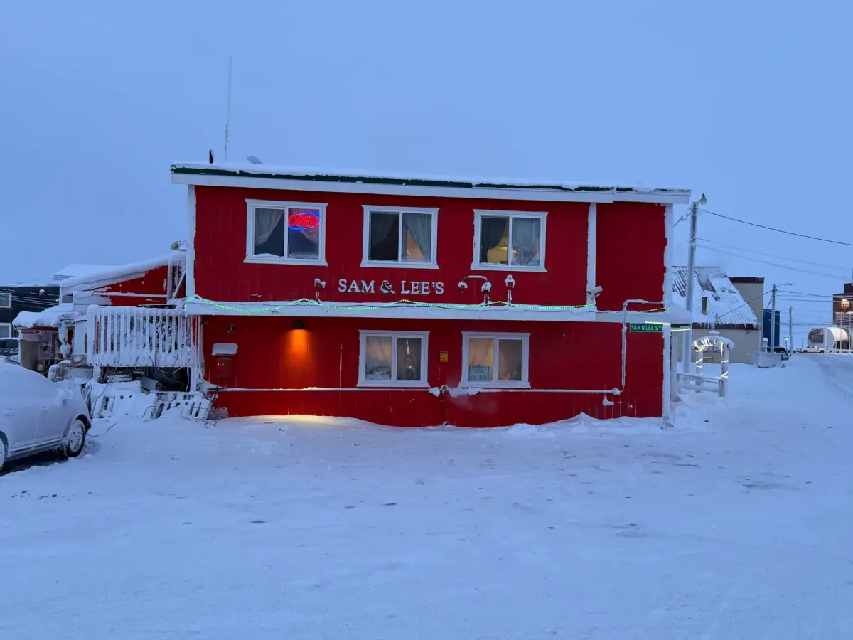 Sam & Lee's Restaurant lit up at twilight on Kogiak Street, Utqiagvik