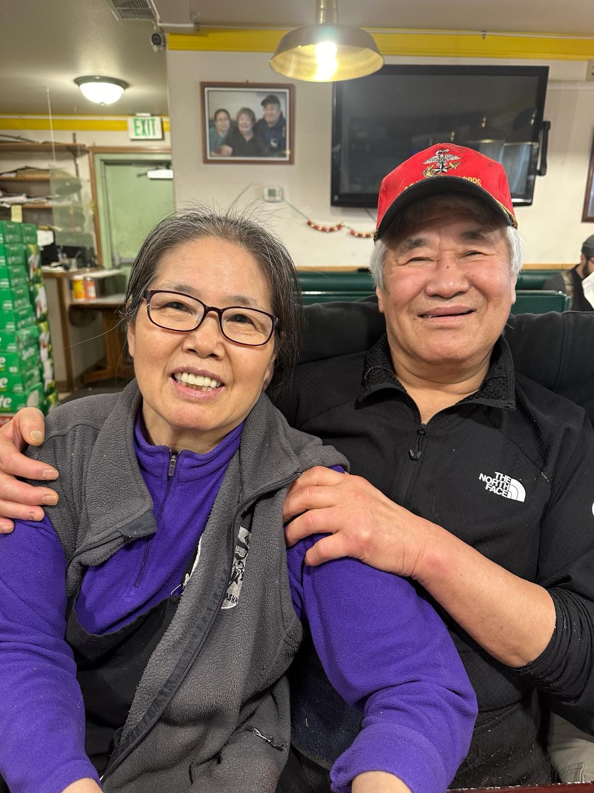 Mr. and Mrs. Kim seated together in the dining room